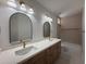Bathroom with a dual sink vanity, modern mirrors and lighting at 11006 S Indian Wells Dr, Goodyear, AZ 85338