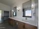 Spacious bathroom with dual vanities, framed mirrors, and walk-in closet at 11006 S Indian Wells Dr, Goodyear, AZ 85338