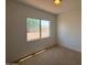 Bright bedroom with carpet and window view of neighboring homes at 11006 S Indian Wells Dr, Goodyear, AZ 85338