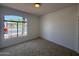 Cozy bedroom with carpet, window view of the neighborhood street at 11006 S Indian Wells Dr, Goodyear, AZ 85338