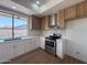 Bright kitchen featuring quartz countertops, stainless steel appliances, and modern white cabinets at 11006 S Indian Wells Dr, Goodyear, AZ 85338