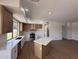 Open kitchen with stainless steel appliances, island and bright lighting at 11006 S Indian Wells Dr, Goodyear, AZ 85338