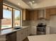 Bright kitchen featuring quartz countertops, stainless steel appliances, and a window overlooking the pool at 11006 S Indian Wells Dr, Goodyear, AZ 85338