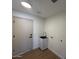 This laundry room features a utility sink with a modern faucet and white cabinets at 11006 S Indian Wells Dr, Goodyear, AZ 85338