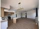 Open living space with wood flooring, island, and contemporary chandelier at 11006 S Indian Wells Dr, Goodyear, AZ 85338