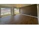 Spacious living area with large windows and modern chandelier at 11006 S Indian Wells Dr, Goodyear, AZ 85338