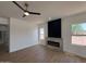 Living room featuring fireplace with ceiling fan and vinyl floors at 11006 S Indian Wells Dr, Goodyear, AZ 85338