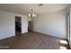 Bright living room boasts hardwood floors and modern light fixture at 11006 S Indian Wells Dr, Goodyear, AZ 85338