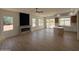 Spacious living room featuring modern fireplace and view of the backyard at 11006 S Indian Wells Dr, Goodyear, AZ 85338