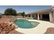 Backyard featuring a sparkling in-ground pool and well-maintained landscaping at 11006 S Indian Wells Dr, Goodyear, AZ 85338
