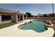 Private backyard pool with rock features and manicured landscaping at 11006 S Indian Wells Dr, Goodyear, AZ 85338