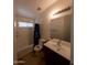 Modest full bathroom with a shower-tub combo, a single-sink vanity and a window for natural light at 1381 E Prickly Pear Dr, Casa Grande, AZ 85122