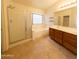 Primary bathroom featuring a glass enclosed shower, soaking tub, and a dual-sink vanity with storage at 1381 E Prickly Pear Dr, Casa Grande, AZ 85122