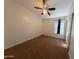 Cozy carpeted bedroom with neutral walls, a ceiling fan, and a window providing natural light at 1381 E Prickly Pear Dr, Casa Grande, AZ 85122