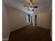 Neutral carpeted bedroom with closet, ceiling fan and a window offering natural light at 1381 E Prickly Pear Dr, Casa Grande, AZ 85122