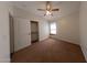 Carpeted bedroom featuring neutral walls, a ceiling fan, and a window allowing natural light at 1381 E Prickly Pear Dr, Casa Grande, AZ 85122