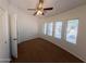 Bedroom with carpet, a ceiling fan, and multiple windows for natural light at 1381 E Prickly Pear Dr, Casa Grande, AZ 85122