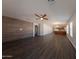 Spacious living room with dark wood-look floors, a ceiling fan, and ample natural light at 1381 E Prickly Pear Dr, Casa Grande, AZ 85122