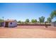 The backyard of the home is enclosed and has a gravel yard. A shed and several trees are included at 17810 N 34Th Pl, Phoenix, AZ 85032