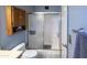 Bathroom featuring a shower, toilet, wall cabinet, and towel bar at 17810 N 34Th Pl, Phoenix, AZ 85032