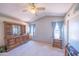 Bedroom with vaulted ceiling features neutral carpet, two windows, and dresser with mirror at 17810 N 34Th Pl, Phoenix, AZ 85032