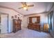 Traditional bedroom featuring two dressers, neutral carpet, a ceiling fan, and decorative wallpaper border at 17810 N 34Th Pl, Phoenix, AZ 85032