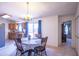 Bright dining room featuring a chandelier and access to the kitchen and backyard with a table for four at 17810 N 34Th Pl, Phoenix, AZ 85032