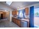 Bright kitchen showcasing a window, stainless steel appliances, and wood cabinets at 17810 N 34Th Pl, Phoenix, AZ 85032