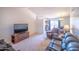 Bright, open-concept living area with vaulted ceilings, neutral carpeting, and comfortable leather seating at 17810 N 34Th Pl, Phoenix, AZ 85032