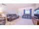 Spacious living room featuring plush carpeting, comfortable leather seating, and a bright, airy atmosphere at 17810 N 34Th Pl, Phoenix, AZ 85032
