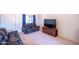 Cozy living room featuring comfortable seating, a modern TV, and neutral decor with bright light at 17810 N 34Th Pl, Phoenix, AZ 85032