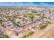 Expansive aerial view of a residential neighborhood featuring well-maintained homes and green spaces at 18774 N Ibis Way, Maricopa, AZ 85138