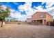 View of the house from spacious gravel backyard with block fence at 18774 N Ibis Way, Maricopa, AZ 85138