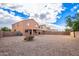 Gravel backyard with block fence and view of neighboring homes at 18774 N Ibis Way, Maricopa, AZ 85138