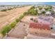 Aerial view of backyard with block fence, covered patio, and neighborhood in the background at 18774 N Ibis Way, Maricopa, AZ 85138