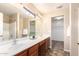 Bathroom features double sinks, vanity with wood cabinets and a separate shower at 18774 N Ibis Way, Maricopa, AZ 85138
