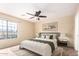 Beautiful bedroom with neutral colors, ceiling fan and plenty of natural light at 18774 N Ibis Way, Maricopa, AZ 85138
