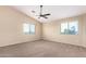 Bedroom features a ceiling fan, window and soft carpet flooring at 18774 N Ibis Way, Maricopa, AZ 85138