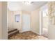Bright foyer featuring a view of the entryway and a carpeted staircase, creating a welcoming atmosphere at 18774 N Ibis Way, Maricopa, AZ 85138