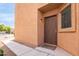 Welcoming front door entrance with a secure lock, stylish exterior light, and a small window at 18774 N Ibis Way, Maricopa, AZ 85138