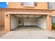 An empty two car garage with lighting, garage door and shelves at 18774 N Ibis Way, Maricopa, AZ 85138