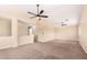 Large living area with neutral walls, carpet, a ceiling fan, and natural light at 18774 N Ibis Way, Maricopa, AZ 85138