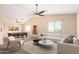 Spacious living room with a ceiling fan, plush seating, pool table and neutral walls at 18774 N Ibis Way, Maricopa, AZ 85138
