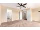 Spacious main bedroom features a ceiling fan and attached bathroom with walk-in closet at 18774 N Ibis Way, Maricopa, AZ 85138