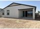 Backyard featuring a covered patio and privacy fencing with a large window at 24105 W Bowker St, Buckeye, AZ 85326