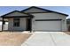 New construction single-story home with a two-car garage and concrete driveway at 24105 W Bowker St, Buckeye, AZ 85326