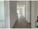 Entryway and hallway featuring wood-look tile flooring and white walls at 24105 W Bowker St, Buckeye, AZ 85326