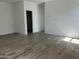 Unfurnished room featuring wood-look tile flooring and natural light at 24105 W Bowker St, Buckeye, AZ 85326