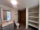 Updated bathroom with shower, shelving, and new vanity at 3143 W Glendale Ave, Phoenix, AZ 85051