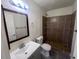Cozy bathroom with a shower, vanity, toilet, updated fixtures and a large mirror at 3143 W Glendale Ave, Phoenix, AZ 85051